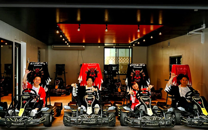 Tourists in themed go-karts at Asakusa indoor track, Tokyo.