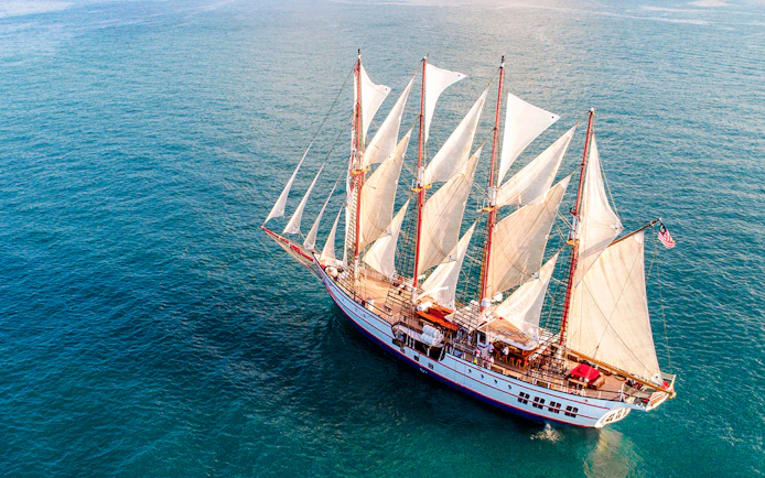 The Royal Albatross sailing on open sea with full sails.