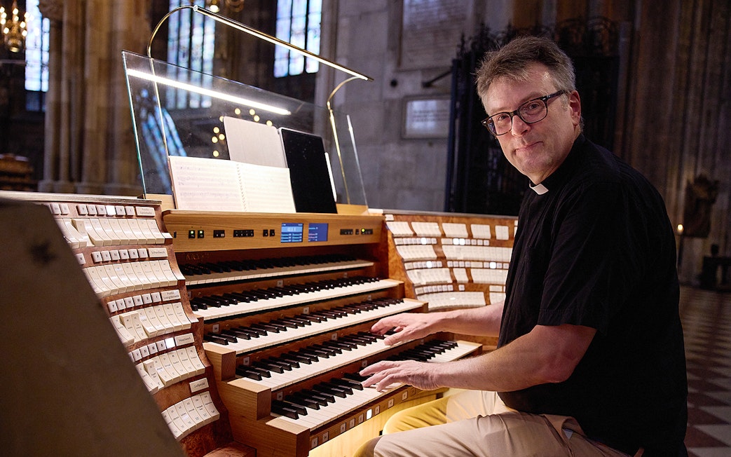 Organist playing the giant organ at St. Stephen's Cathedral concert.