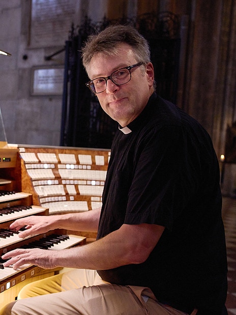 Organist playing the giant organ at St. Stephen's Cathedral concert.