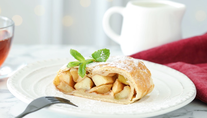 The image shows a slice of apple strudel