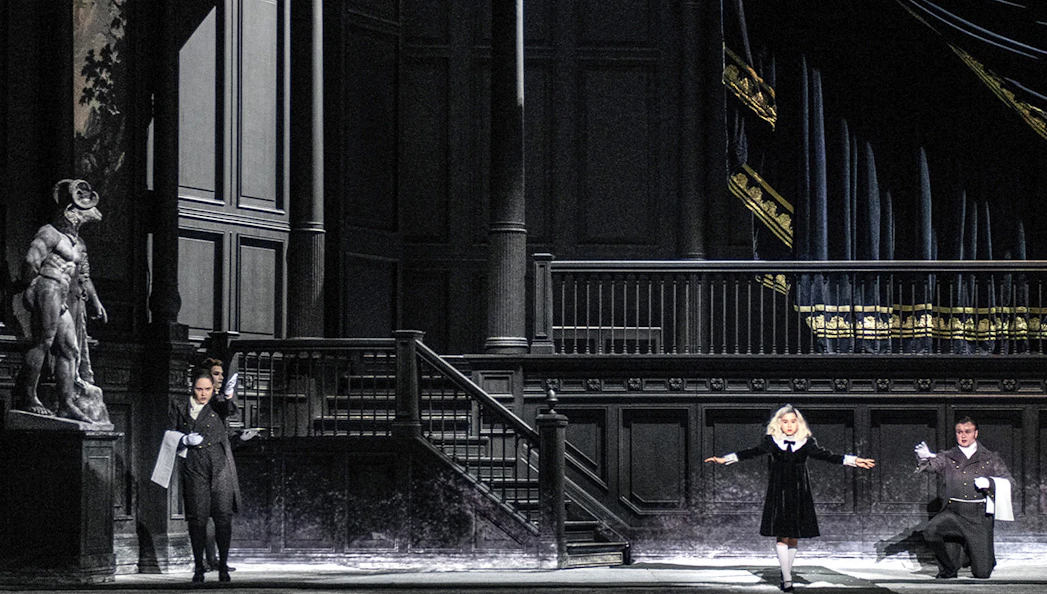 Opera performers on stage during a scene from "Salome" with dramatic lighting and set design.