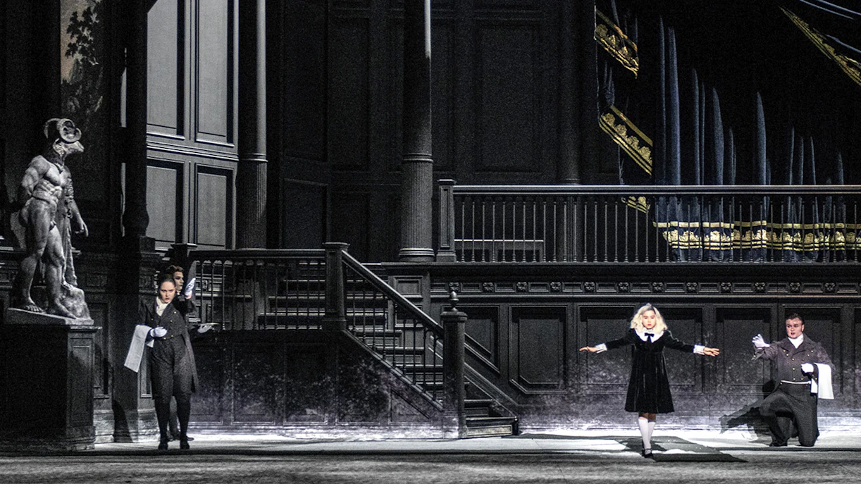Opera performers on stage during a scene from "Salome" with dramatic lighting and set design.
