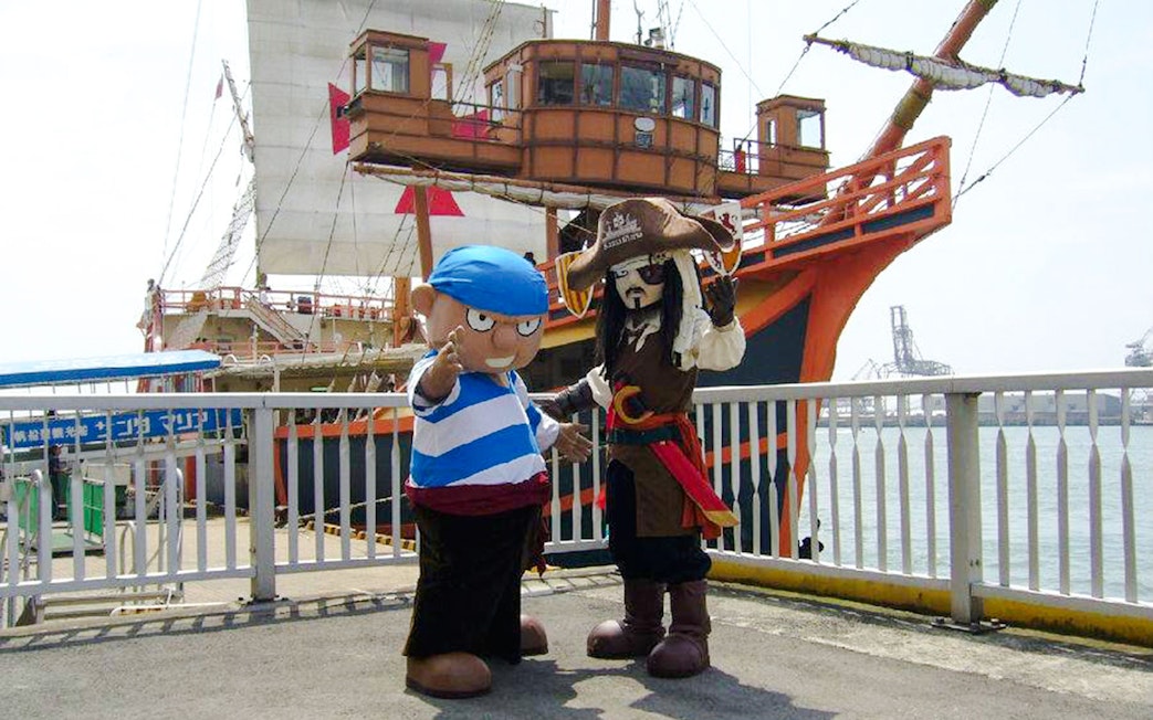 Pirate and sailor mascots on dock in front of Santa Maria cruise ship, Osaka.
