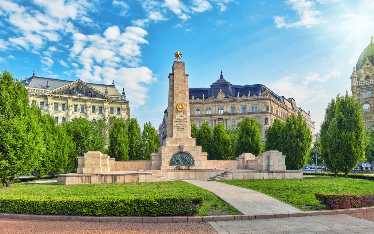 Soviet War Memorial in Liberty Square, Budapest, surrounded by historic buildings.