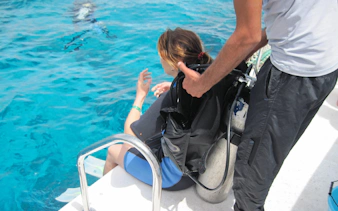 Scuba diver preparing to enter the Red Sea from a boat in Hurghada.
