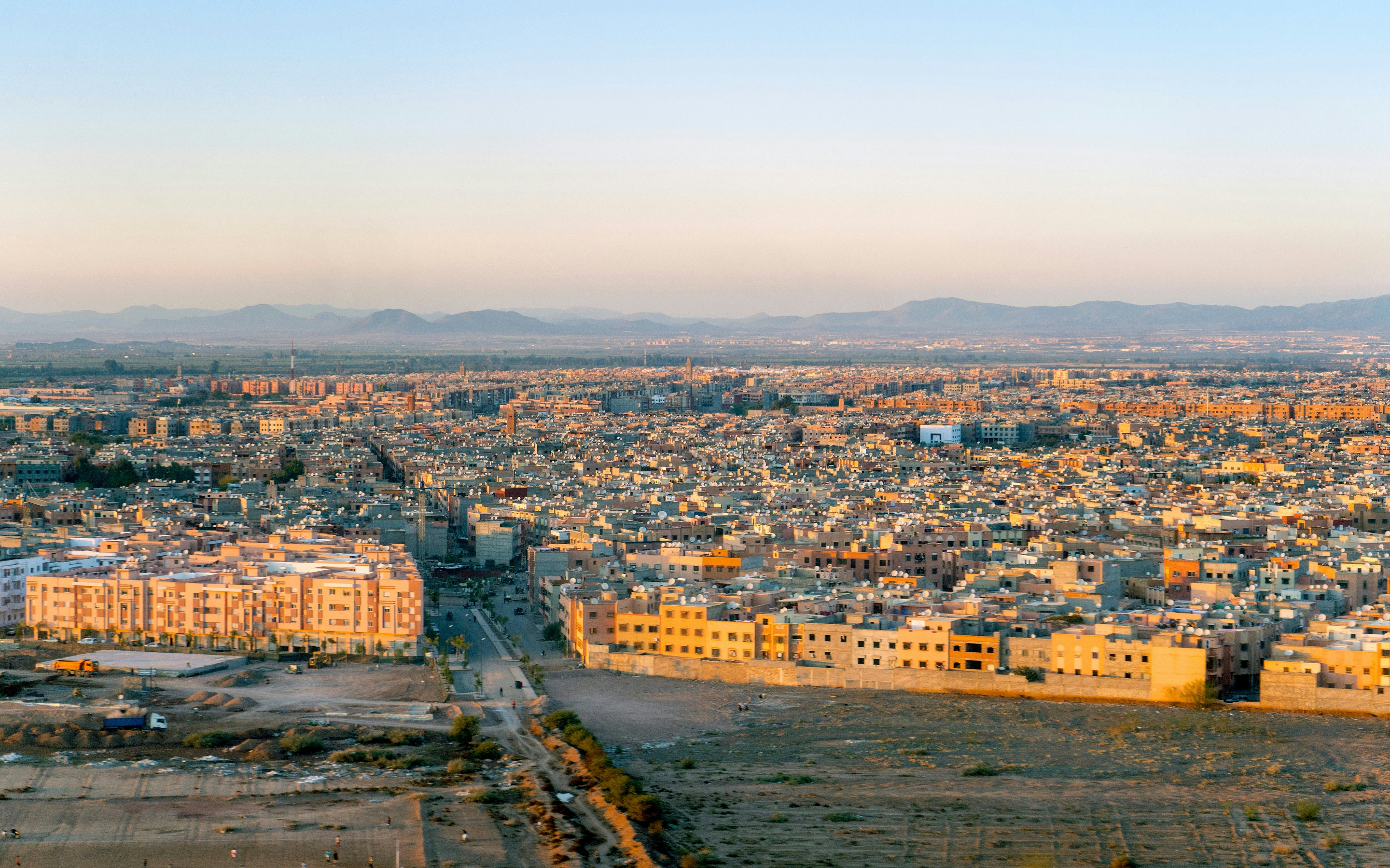 Aerial view of Marrakech residential area with distant mountains, Morocco.
