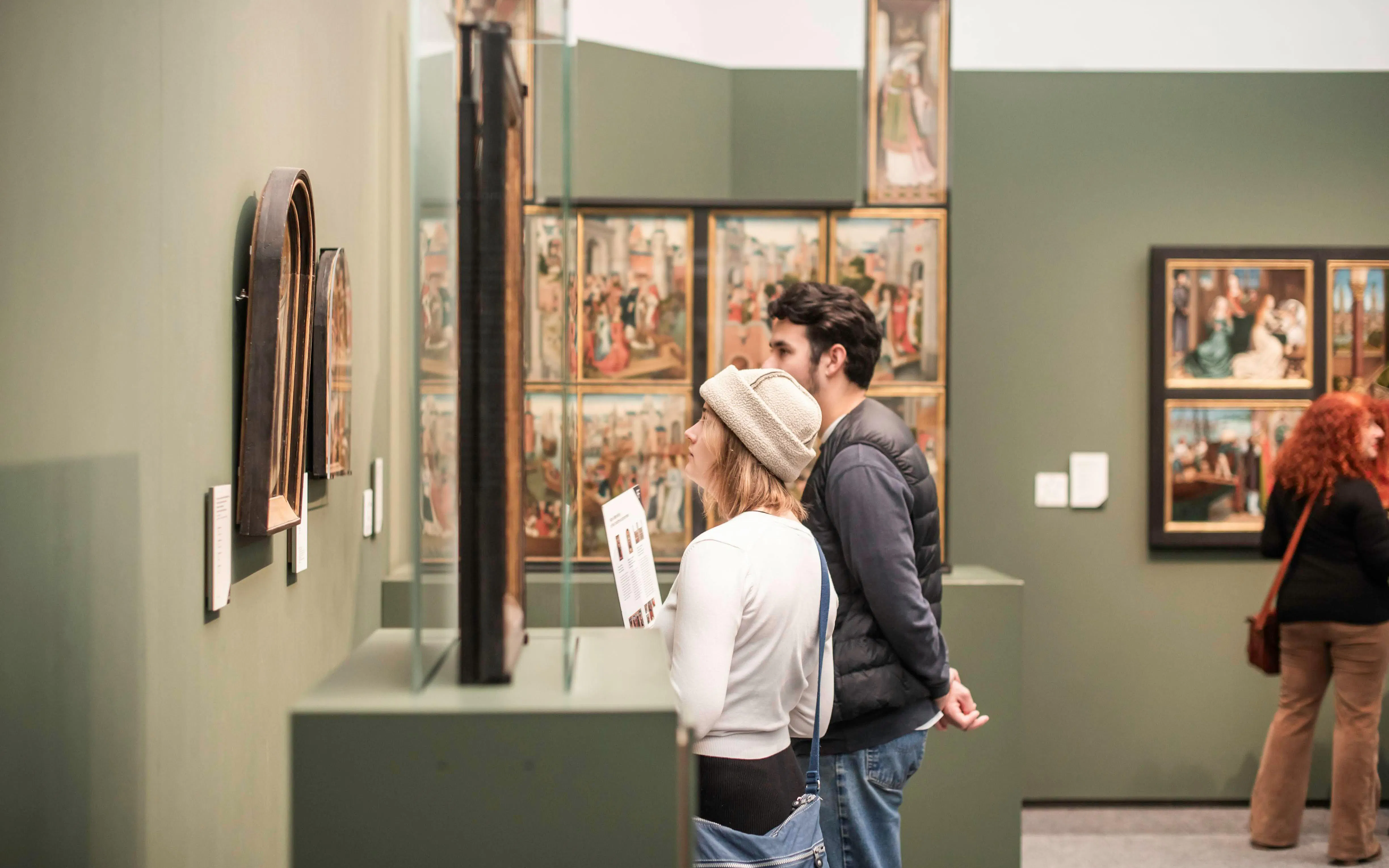 Visitors viewing art at Groeningemuseum in Bruges.