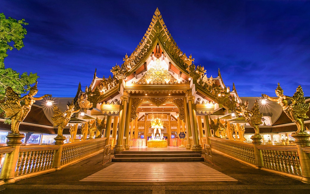 Phuket Fantasea entrance with ornate golden architecture at night.