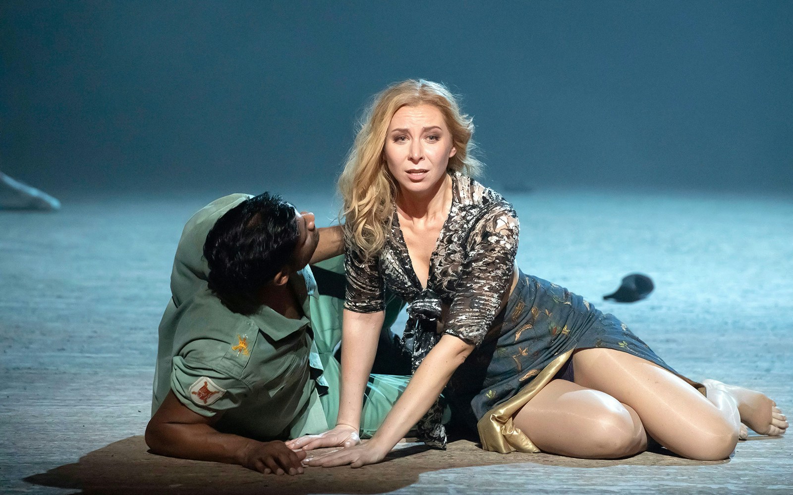 Performers in a dramatic scene from the opera Carmen on stage.