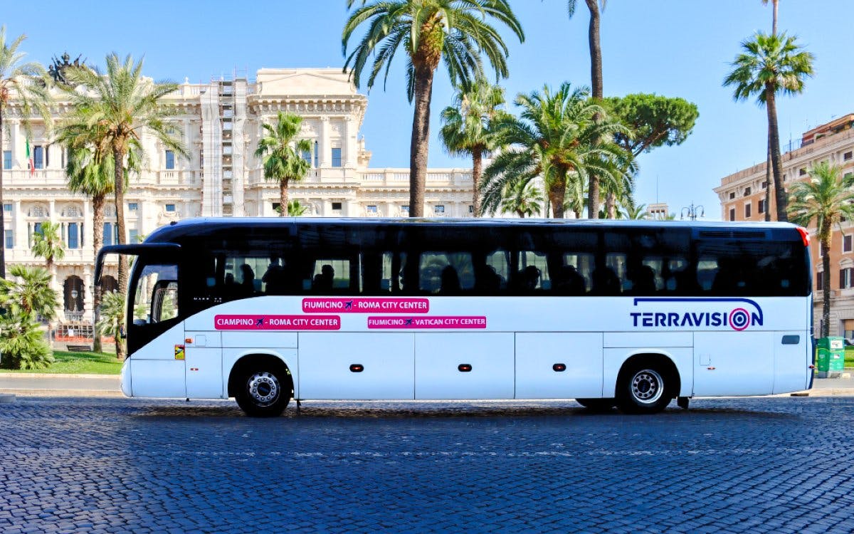Terravision bus at Fiumicino Airport with Rome city center backdrop.