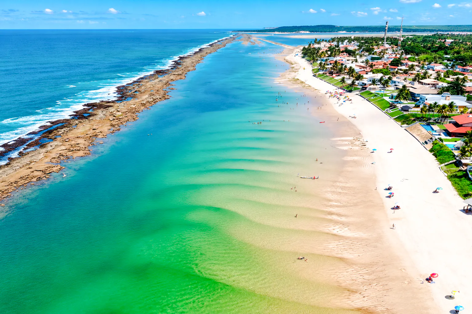 Aerial view of Praia do Francês beach with turquoise waters and sandy shoreline in Maceió, Brazil.