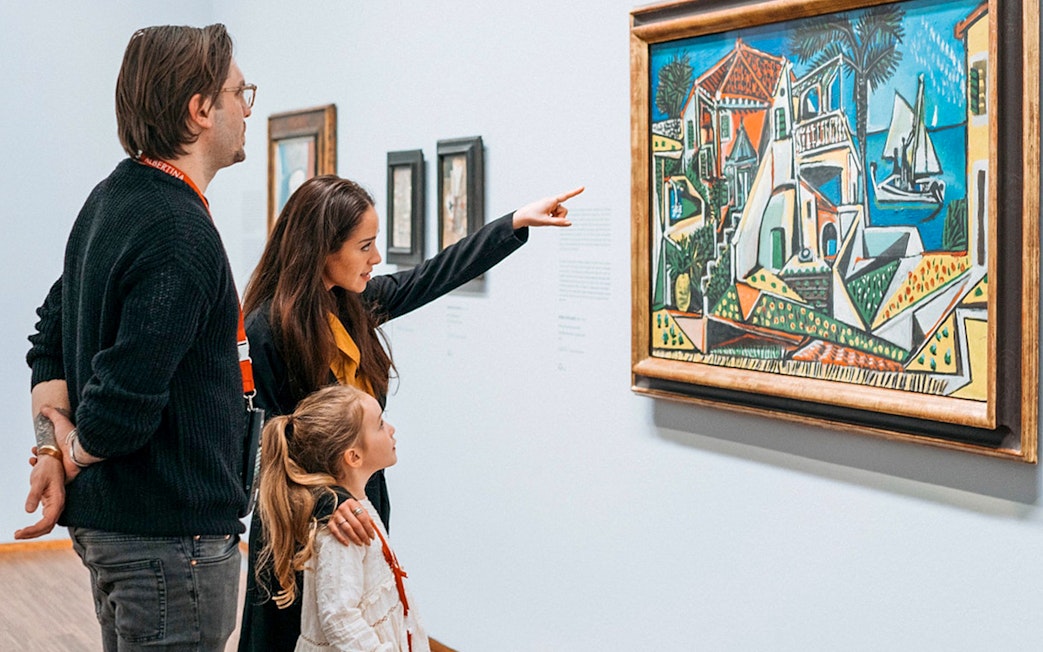 Guests viewing a painting at Albertina Museum exhibit.