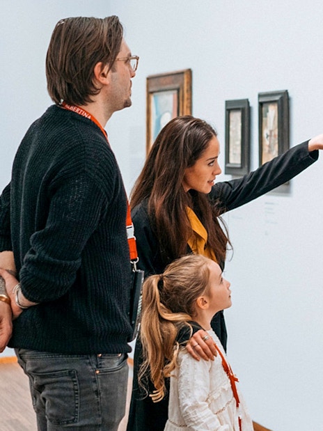 Guests viewing a painting at Albertina Museum exhibit.