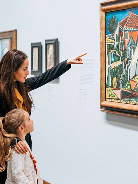 Guests viewing a painting at Albertina Museum exhibit.
