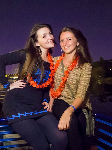 Two people enjoying a night boat party on the Vltava River in Prague.