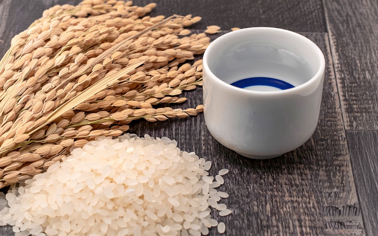 Sake cup with rice grains and stalks, Nagano sake brewery tour.