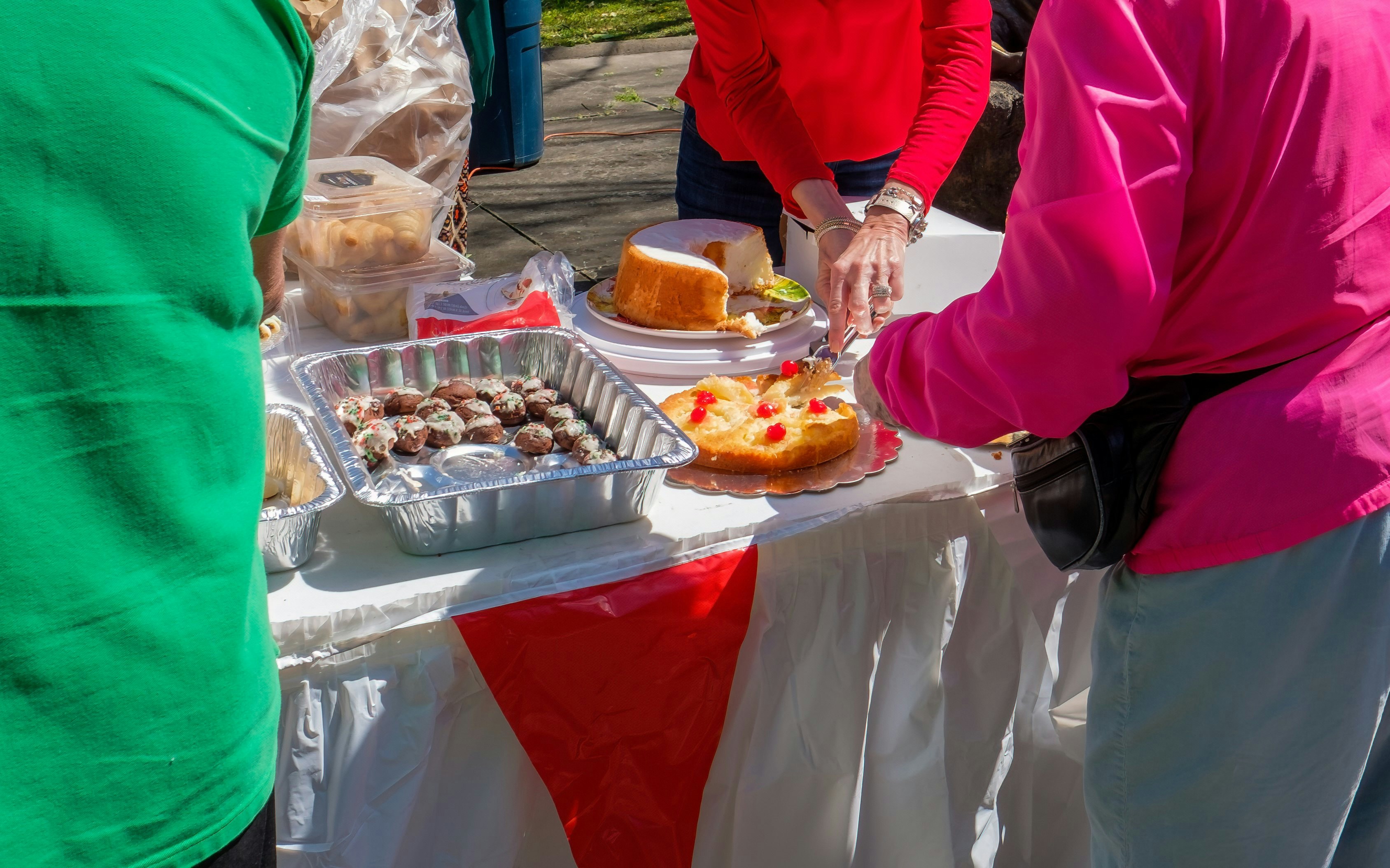 Food stalls at Feast of Saint Joseph with cakes and pastries being served.