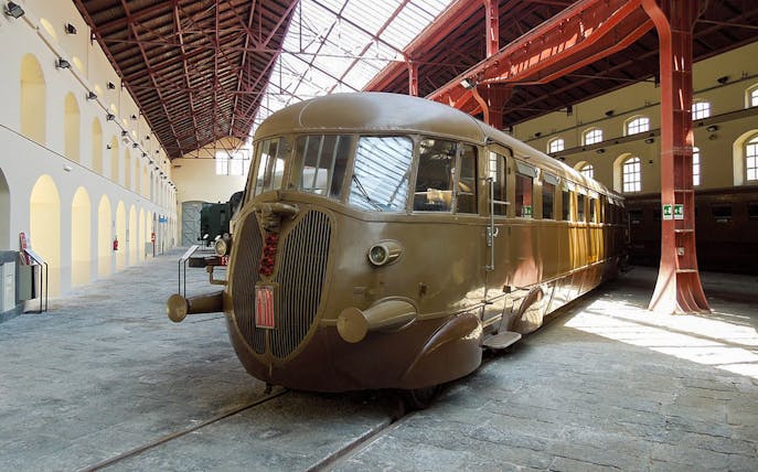 Historic train inside Pietrarsa Railway Museum, Naples, on guided tour and city transfer.