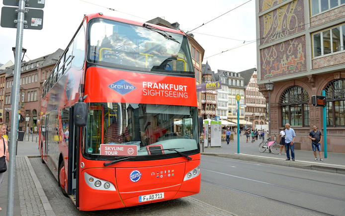 Frankfurt sightseeing bus for Skyline Hop-On Hop-Off tour on city street.