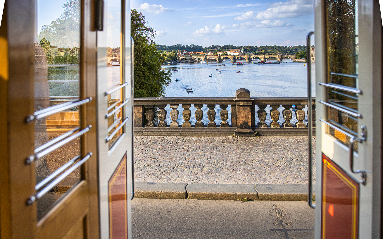 Scenic view of the canal as seen from the inside of the tram, with its vintage doors open