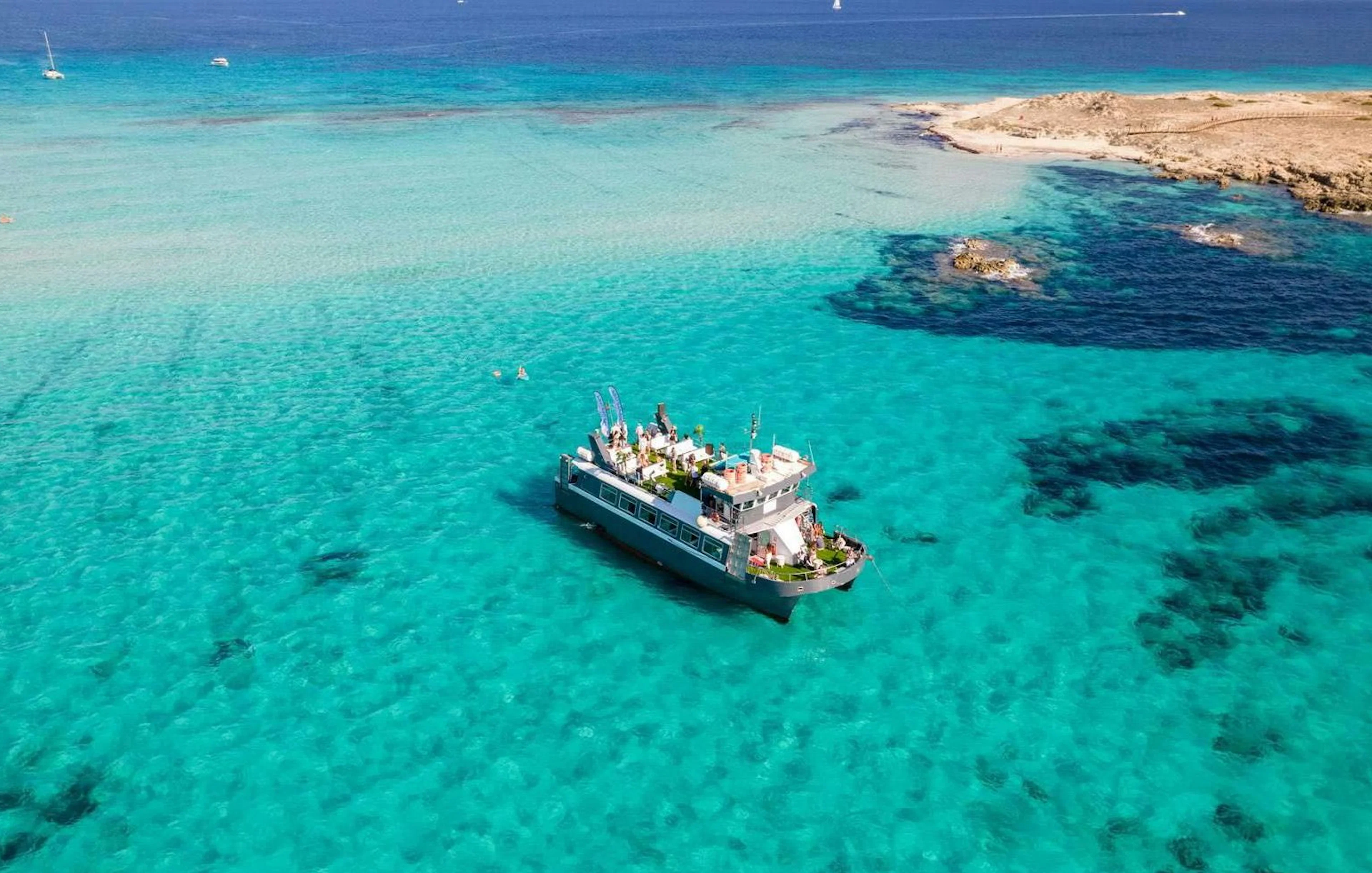 Cruise ship on turquoise waters between Ibiza and Formentera.