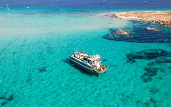 Cruise ship on turquoise waters between Ibiza and Formentera.
