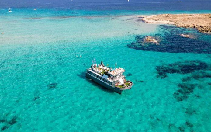 Cruise ship on turquoise waters between Ibiza and Formentera.