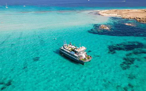 Cruise ship on turquoise waters between Ibiza and Formentera.