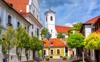 Szentendre Old Town street with colorful buildings and church tower, Hungary.