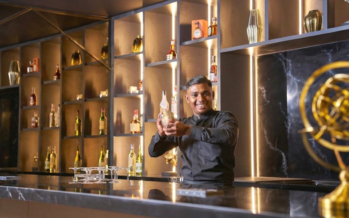 Bartender preparing a drink at Sky Suite Airport Lounge, Terminal 1 & 2.