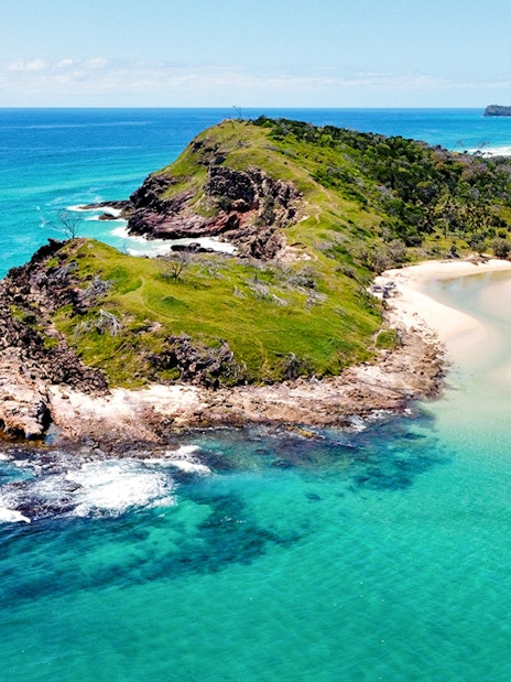 Aerial view of Fraser Island's coastline, K'gari, with turquoise waters and sandy beaches.