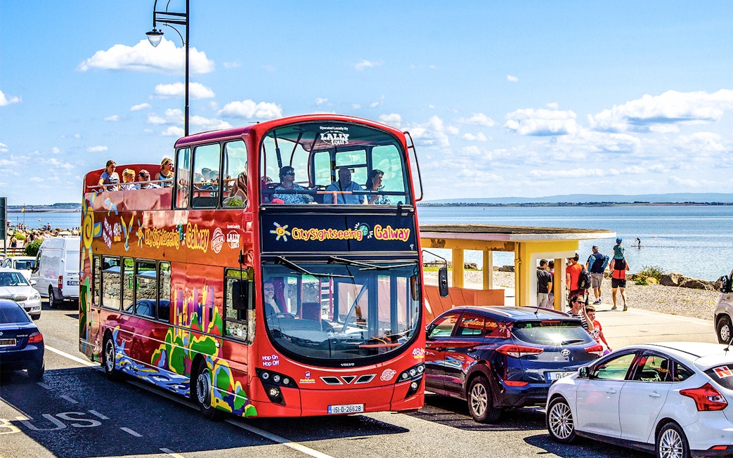 Double-decker bus on Galway Hop-On-Hop-Off Tour by the seaside.