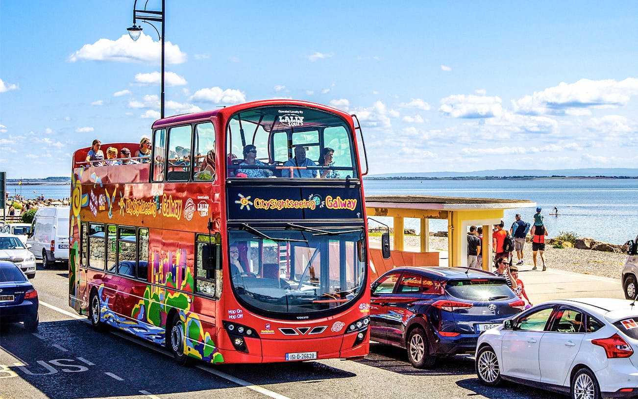 Double-decker bus on Galway Hop-On-Hop-Off Tour by the seaside.
