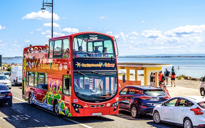 Double-decker bus on Galway Hop-On-Hop-Off Tour by the seaside.