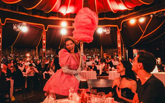 Performer in pink costume entertaining guests at The Mirage dinner show, Vienna.