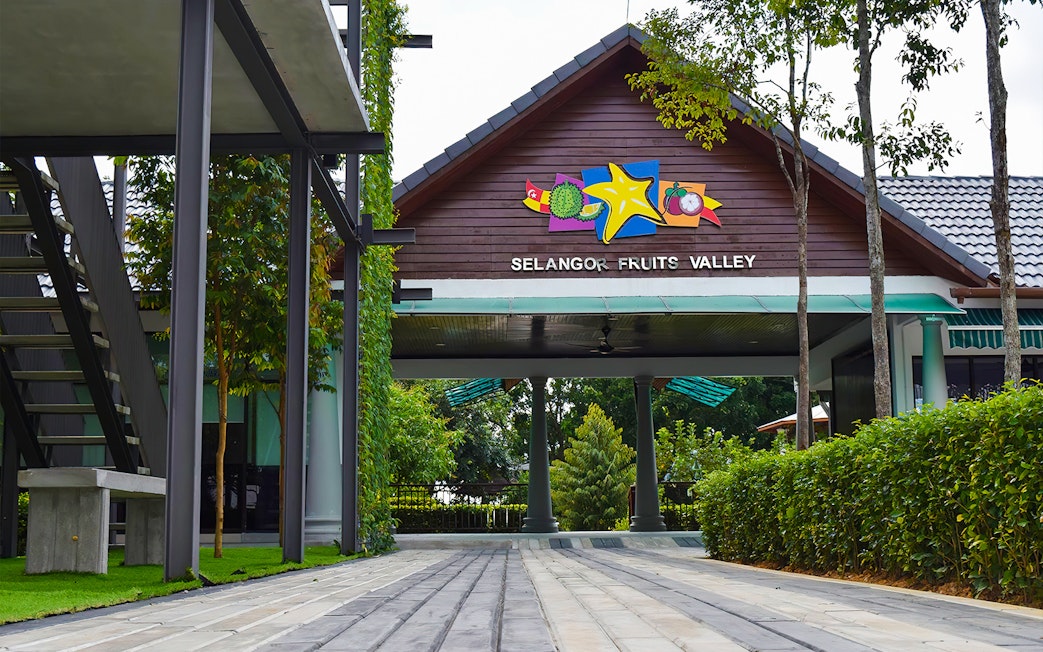 Entrance to Selangor Fruit Valley with colorful fruit signage and lush greenery.