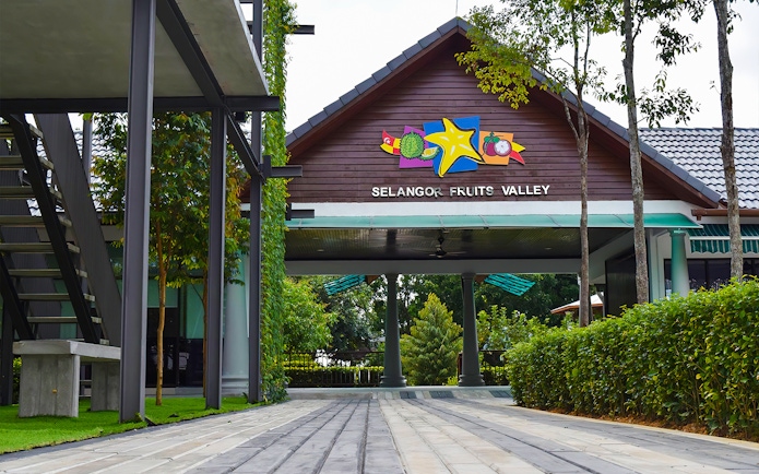 Entrance to Selangor Fruit Valley with colorful fruit signage and lush greenery.
