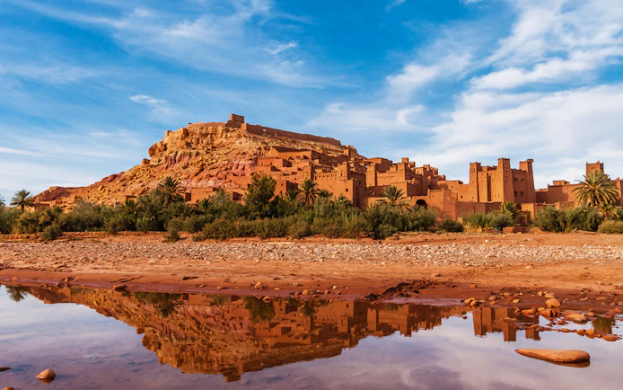 Tourists exploring Ait Benhaddou's historic kasbahs in Ouarzazate, Morocco.