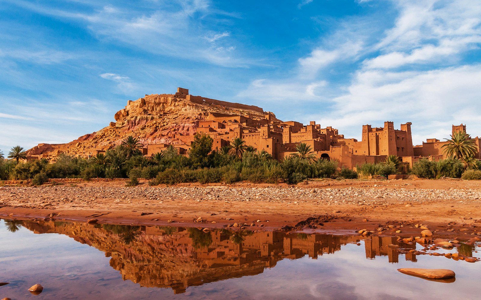 Group of tourists exploring the historic Ait Benhaddou in Ouarzazate on a day trip from Marrakech