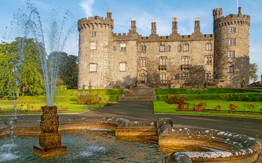 Kilkenny Castle with fountain and gardens in Kilkenny, Ireland.