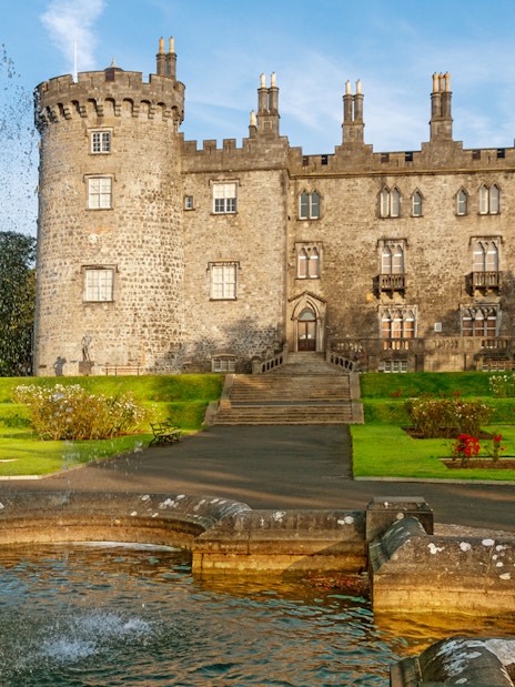 Kilkenny Castle with fountain and gardens in Kilkenny, Ireland.