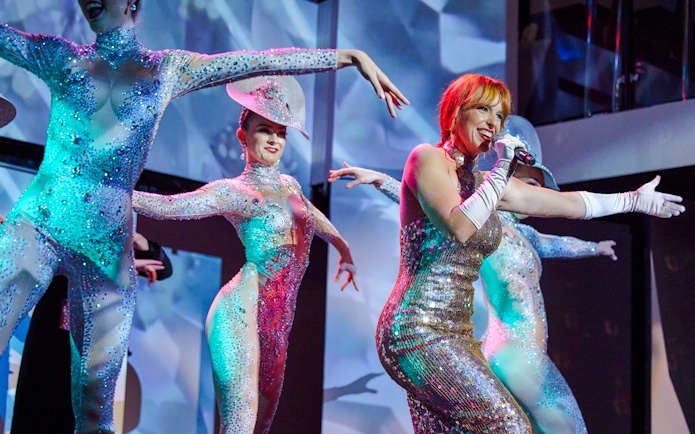 Cabaret performers in sequined costumes on Showboat Vivid Sydney dinner cruise.