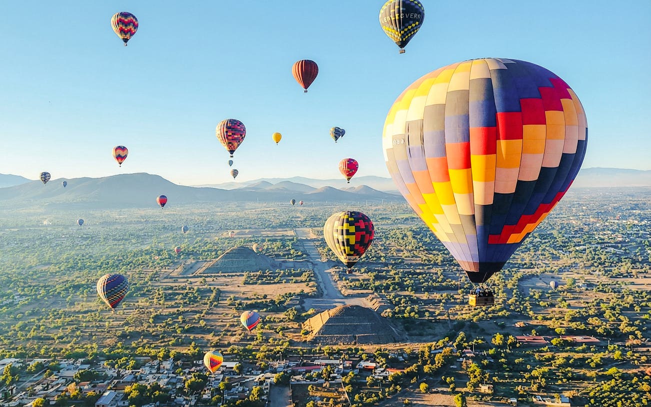 Hot air balloons over Teotihuacan pyramids near Mexico City.