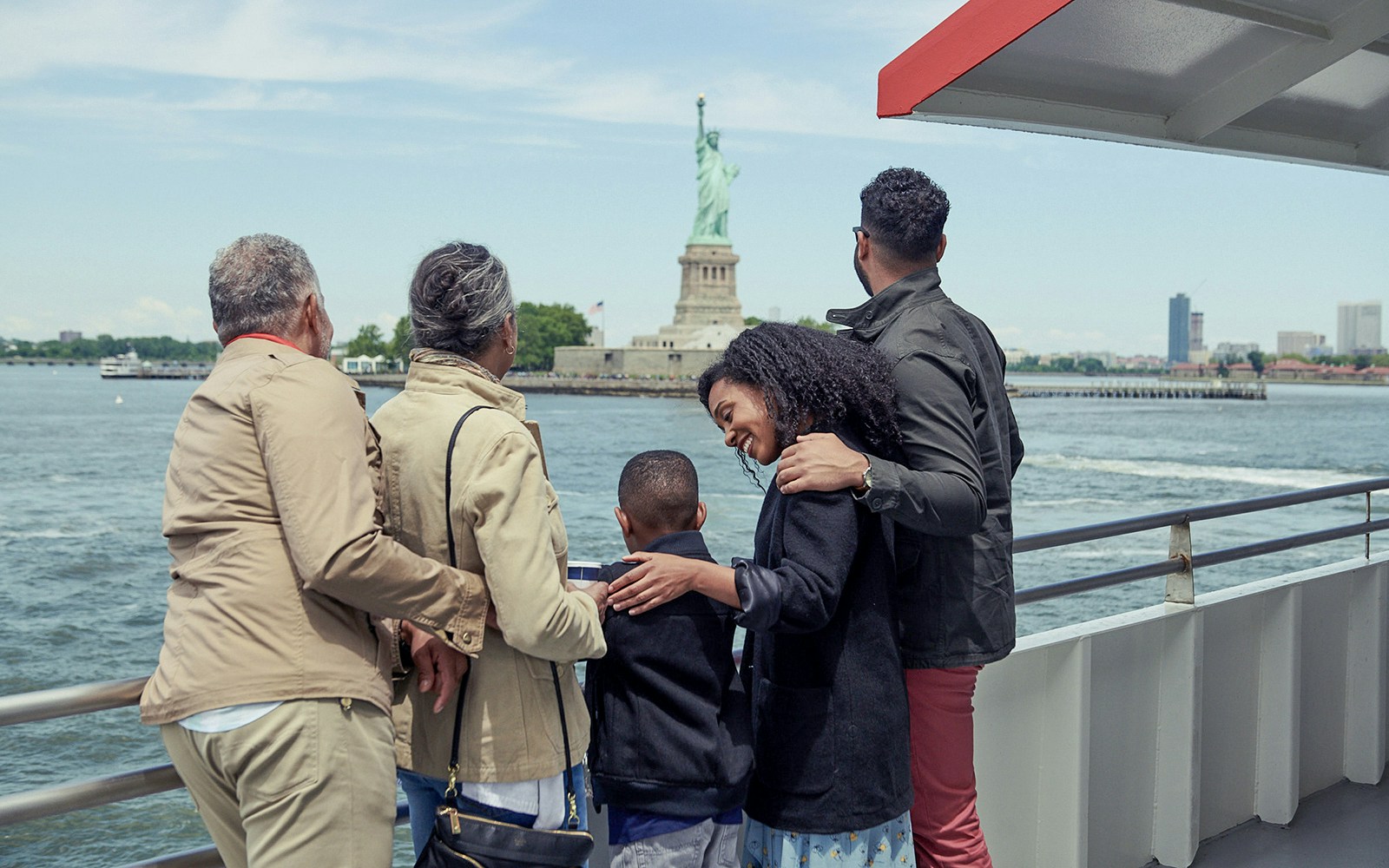 Family watching the Statue of liberty during Liberty Super Express cruise tour