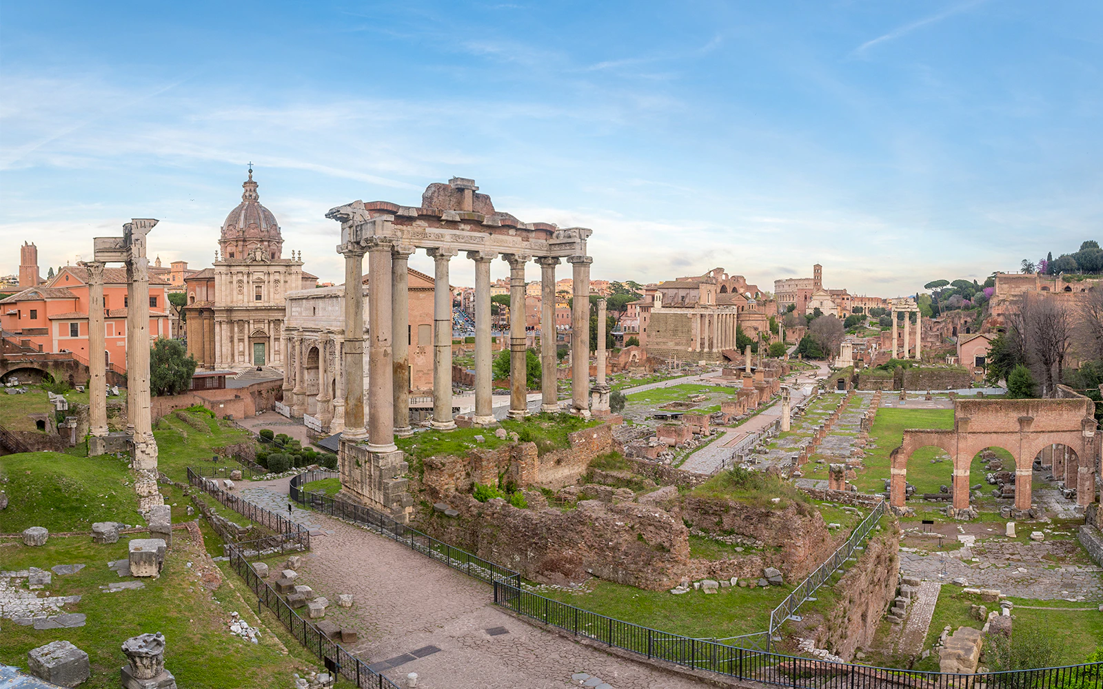 Roman Forum ruins viewed from Palatine Hill, Rome, showcasing ancient columns and structures.