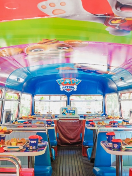 Paw Patrol themed interior of Brigit’s Afternoon Tea Bus Tour with tables set for dining.