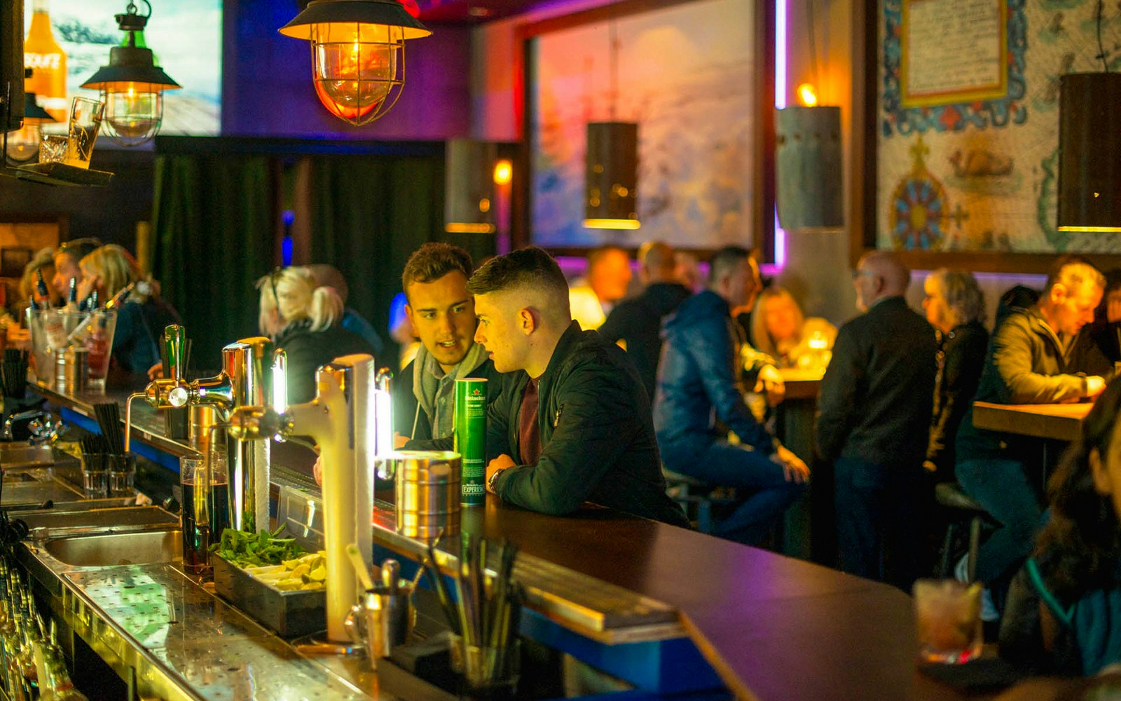 Bar scene at Icebar Amsterdam with patrons enjoying drinks.