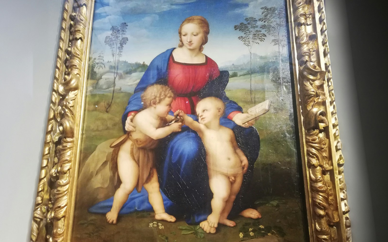 Madonna of the Goldfinch by Raphael, depicting Mary with two children in a landscape.