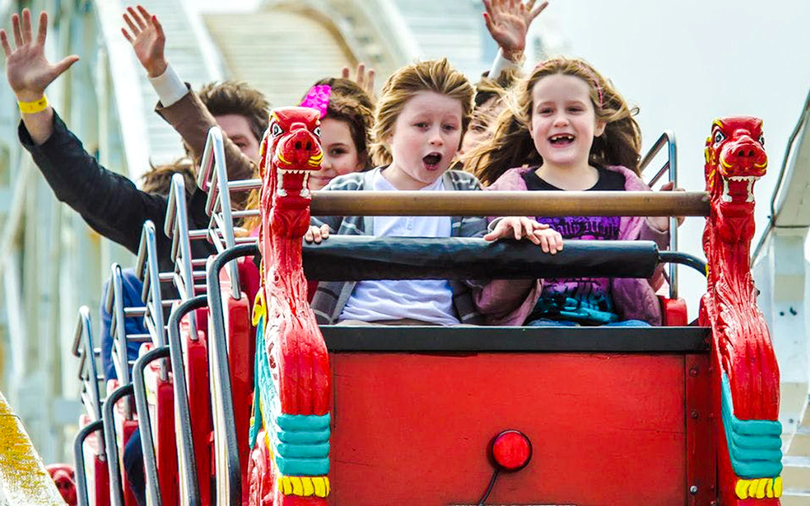 Children enjoying a roller coaster ride at Luna Park Melbourne.